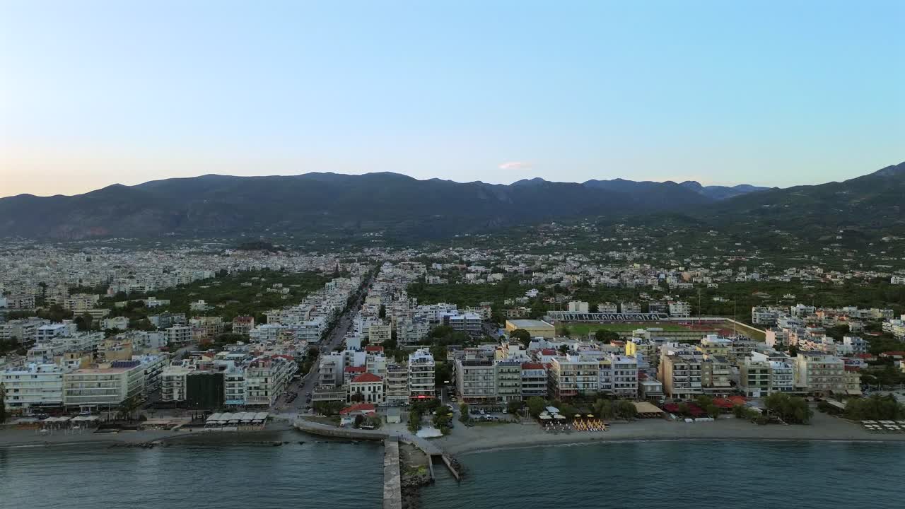 Aerial high angle, push in footage of Kalamata, Iroon street visible on a clear sky spring day 4K