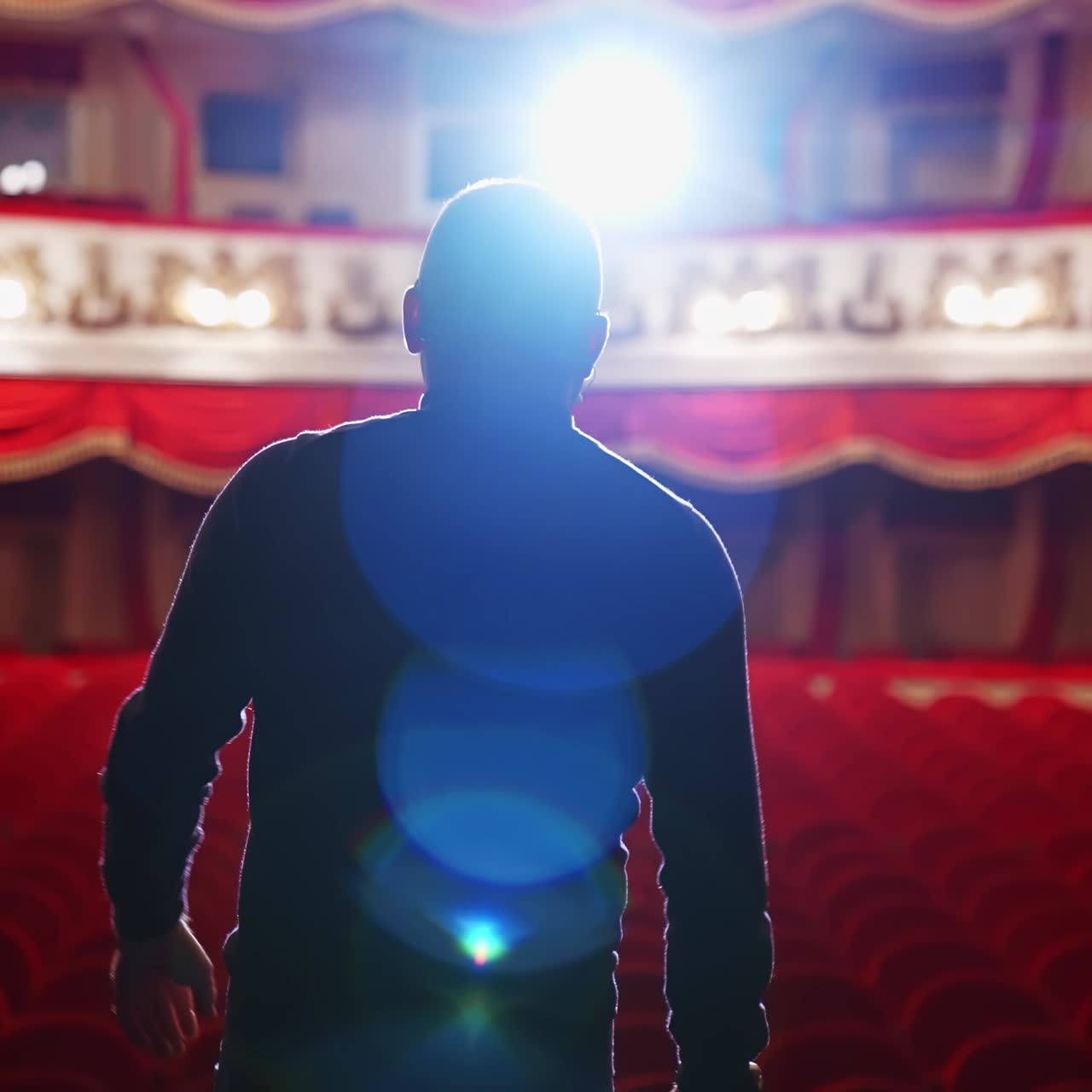 Theater auditorium with no people. Actor on a stage in front of empty hall