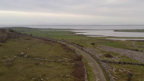 dynamic aerial shot following a trekking trial in the burren, county clare