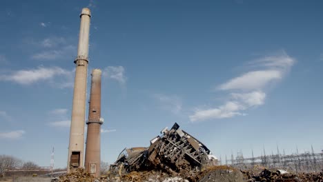 old smoke stacks next to demolished coal fired power plant ruins