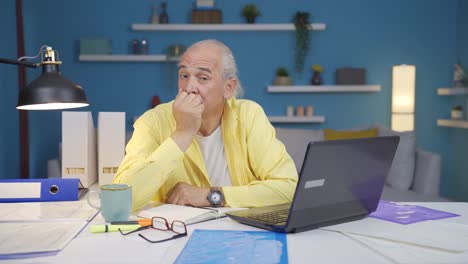 home office worker old man thinking looking at camera.