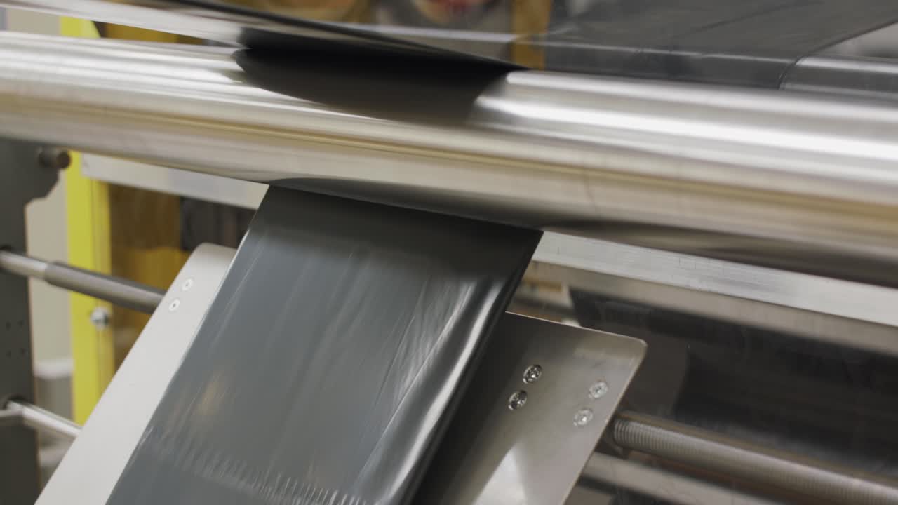 Plastic Bin Bags Production and Black Trash Bags. The plastic bag manufacturing process. Modern plastic factory.