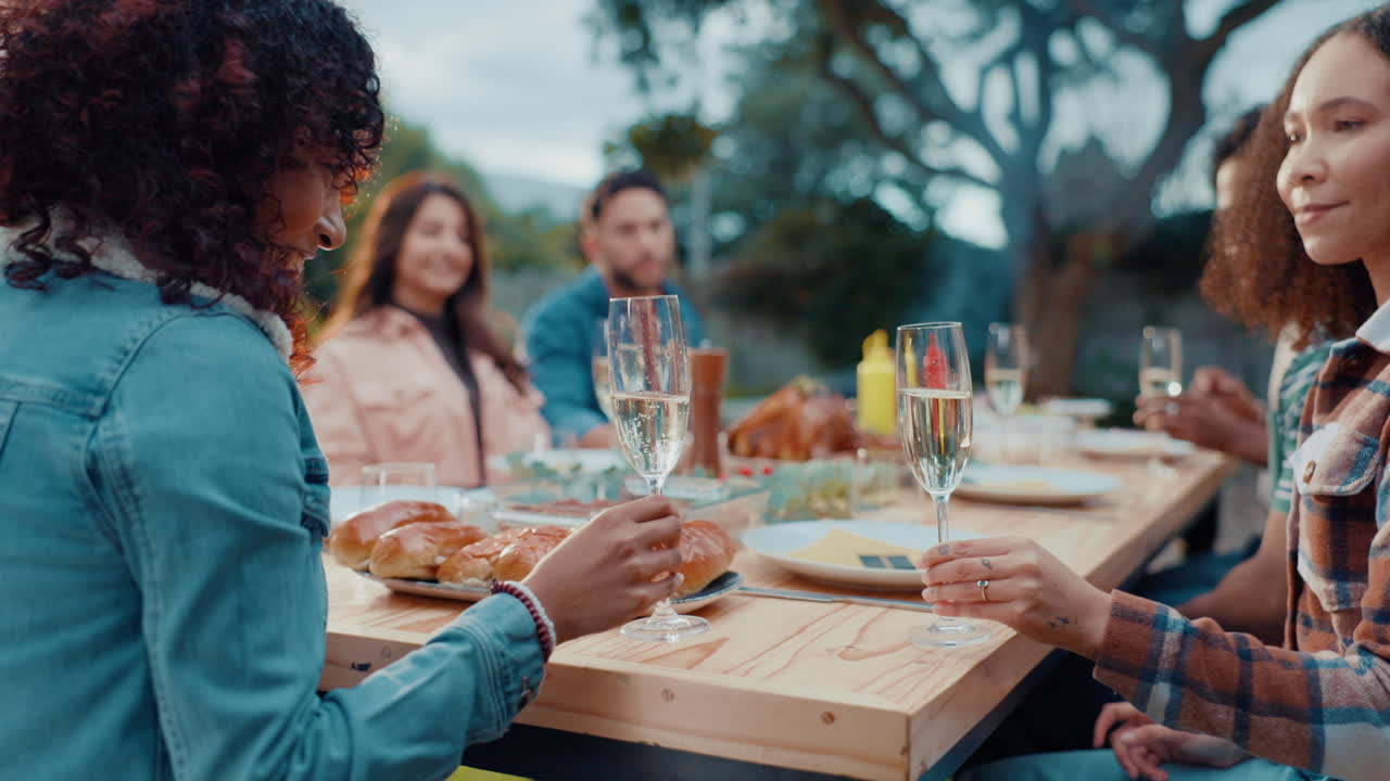 Friends toasting champagne at an outdoor gathering