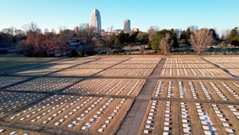 aerial-panning-graves-at-god's-acre-with-winston-salem-nc,-north-carolina-in-foreground