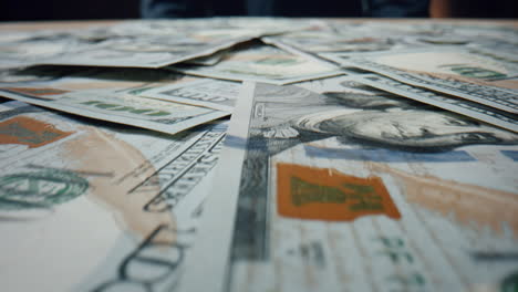 dollar bills falling heap close up. paper american currency scattering on table.