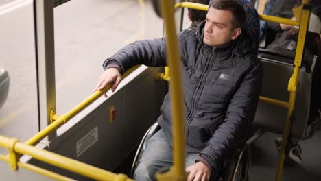 person with a physical disability inside public transport with an accessible ramp