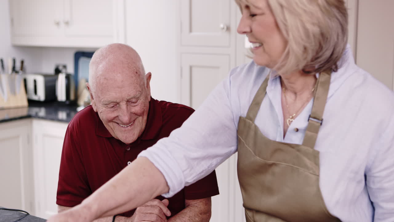 Elderly couple cooking together in the kitchen