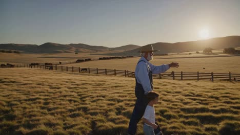 grandpa and grandson on the ranch at sunset