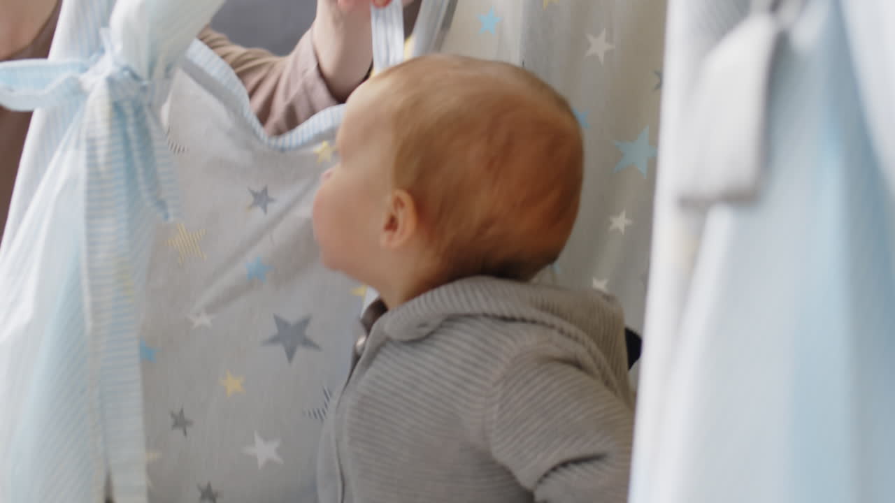 Bambini seduti in un teepee e che giocano con la madre
