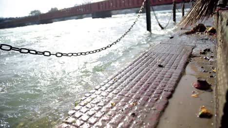 man brooming the dock of ganges river