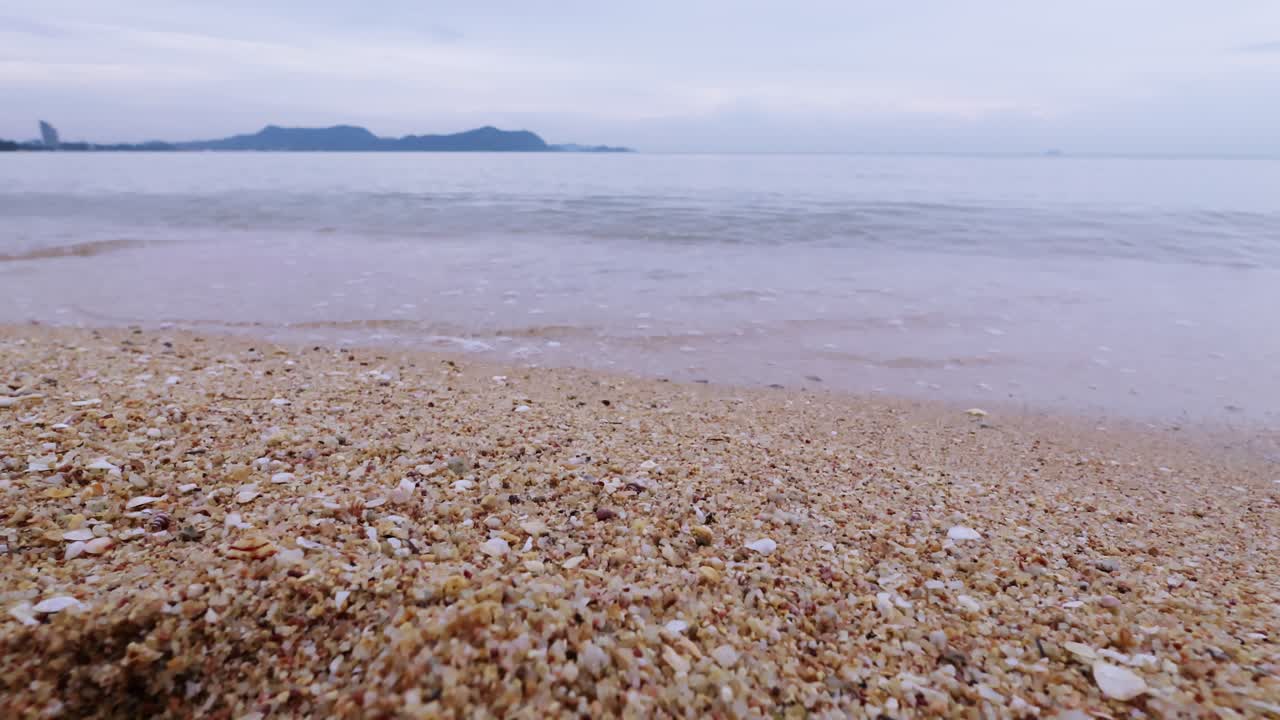 A serene scene of gentle waves washing over a sandy beach inviting relaxation and tranquility.