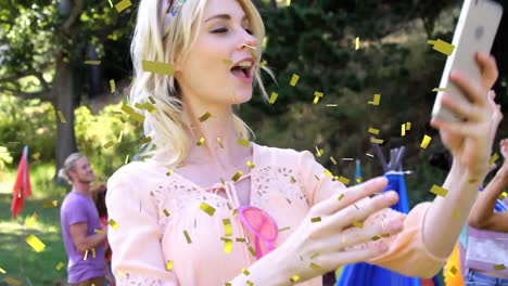 Animation-of-confetti-falling-over-woman-taking-selfie-at-summer-camp