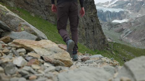 hiker hiking between mountains