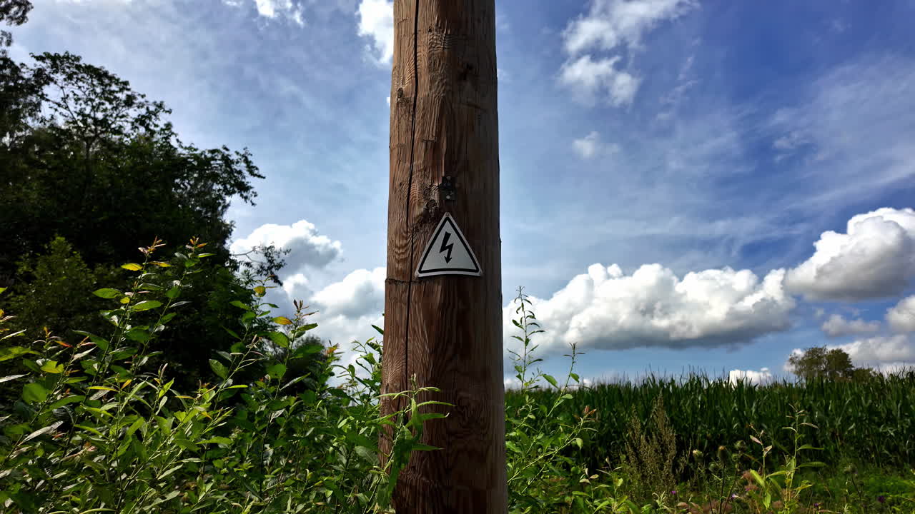 Triangle plaque depicting a lightning bolt icon on a white background to mark high voltage electricity poles