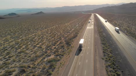 Aerial-View-Of-Daytime-Traffic-On-Interstate-15-Through-Desert-Landscape-In-Baker,-California