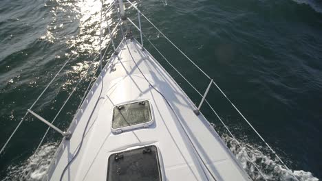 ocean waves and water splashing on bow of sailing boat in alaska. - pov