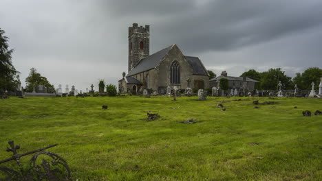 time lapse of historical cemetery and medieval church in rural ireland with passing clouds and sunshine