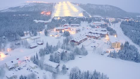 Drone-aerial-flyover-closeup-,-Levi,-Finland-village-snowy-neighborhood-with-police-incident-crash-on-road