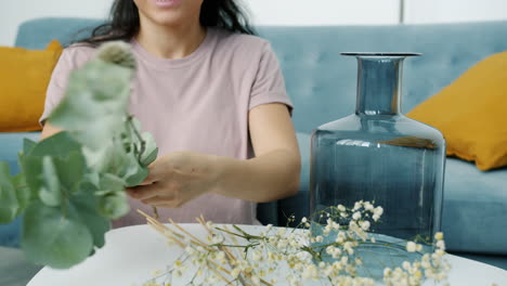 woman arranging flowers in a vase