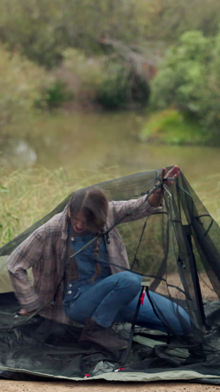 Setting up a tent by the river