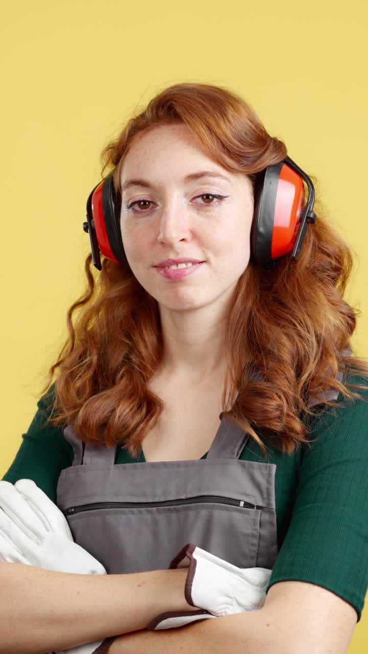 Woman in Construction Gear with Earmuffs and Overalls