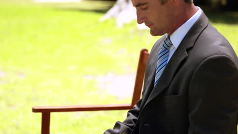 businessman using tablet in the park