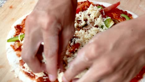 4k footage, close up hand chef putting cheese topping on his pizza base