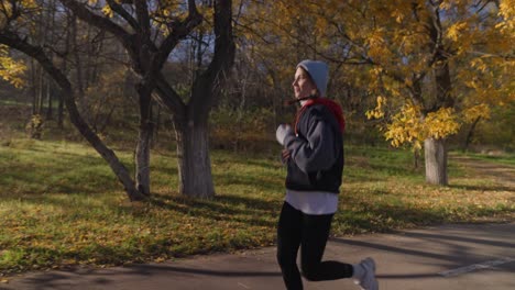 woman running in autumn park