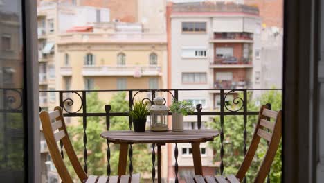 empty beautiful exterior balcony table with no people mediterranean city background during sunny summer day wide shot