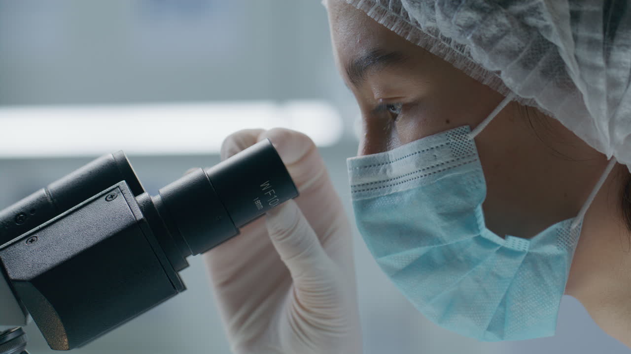 Scientist Performing Detailed Microscopic Analysis in Laboratory