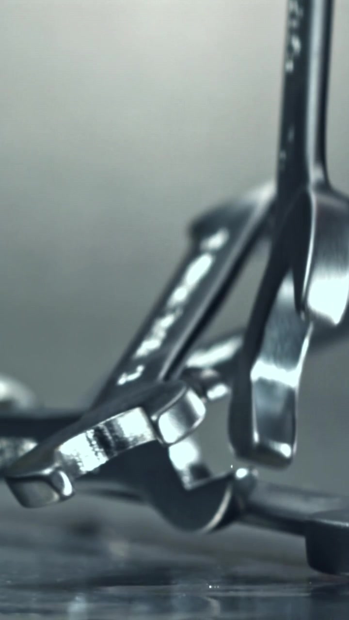 Slow Motion Shot of Metal Wrenches Falling onto a Surface
