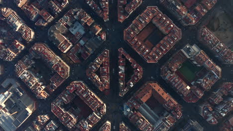 Regular-square-blocks-in-urban-borough-divided-by-Avinguda-Gaudi.-Top-down-shot-of-town-development-at-golden-hour.-Barcelona,-Spain