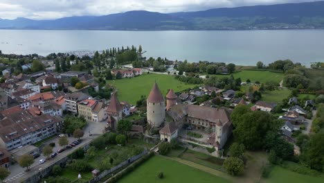 Pull back tilt up drone shot of Chenaux Castle in Estavayer-le-Lac in Canton of Fribourg Switzerland