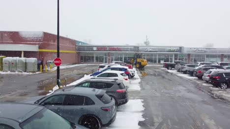 Snowplow-vehicle-removing-snow-on-the-street-of-Pierre-Eliot-Trudeau-International-Airport-in-Montreal,-Quebec,-Canada