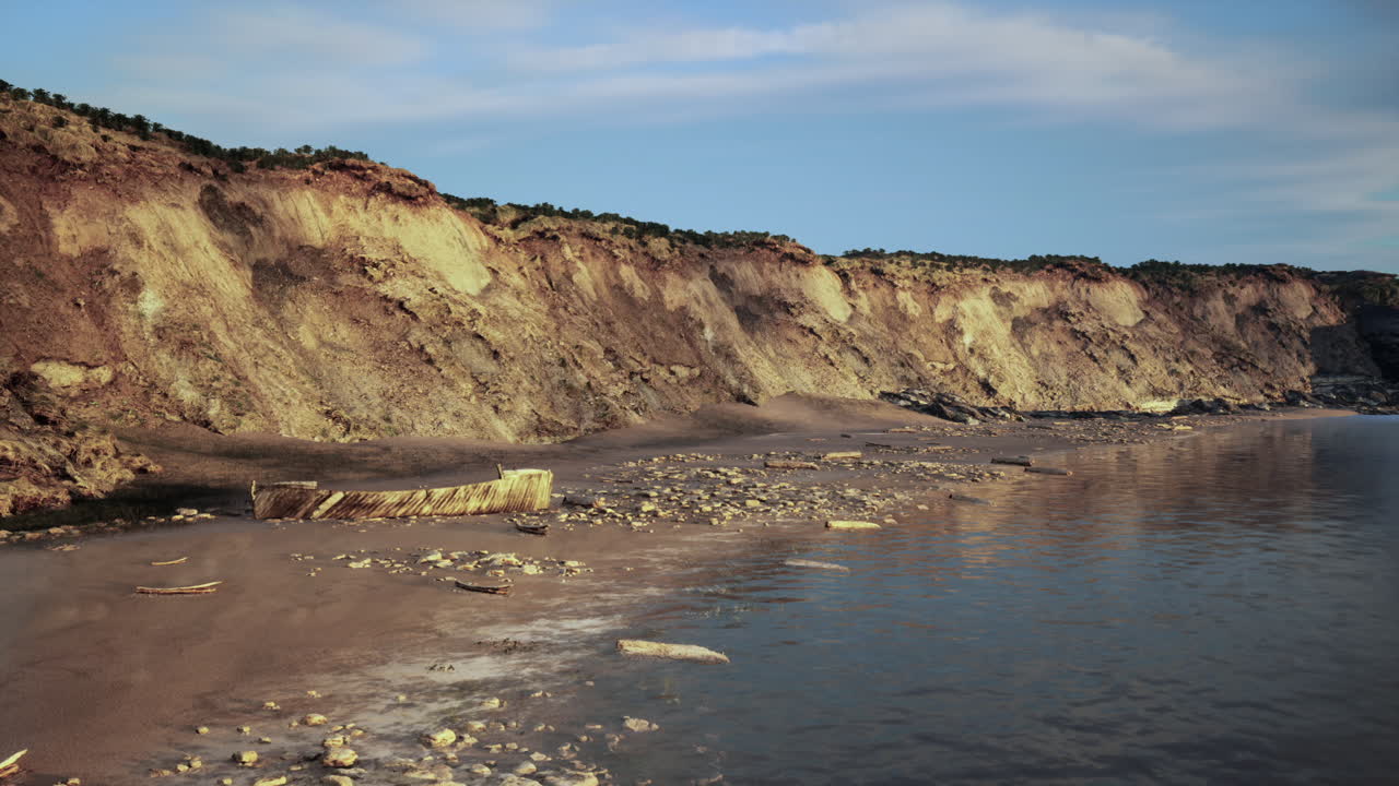 Peaceful shoreline illuminated by sunset with reflective wet sands