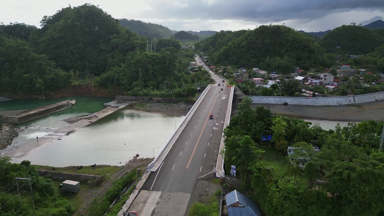Panoramic Aerial View of Bridge Crossing Pajo River with Lush Hills and Small Village Town in Background – Catanduanes, Philippines