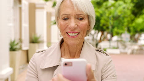Lachende-ältere-Frau,-Die-Am-Telefon-SMS-Schreibt