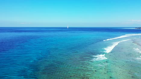 amazing seascape of tropical shore with white waves splashing and foaming slowly over rocky seabed under calm clear water in jamaica