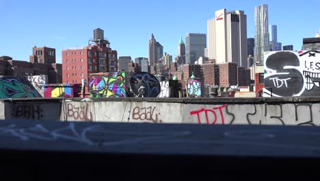 a rooftop view looking across the financial district of new york city to one world trade center 1