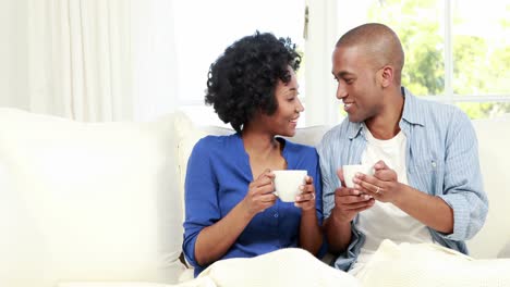 Couple-having-coffee-on-the-couch