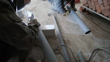 welding work on the assembly of components of the steel pipe by manual arc welding with coated electrodes. construction