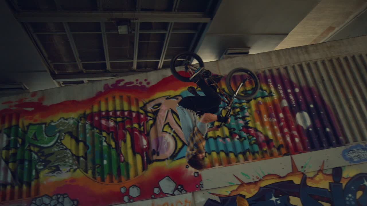 Teenager practicing jump trick on bmx bicycle at urban space. Extreme lifestyle