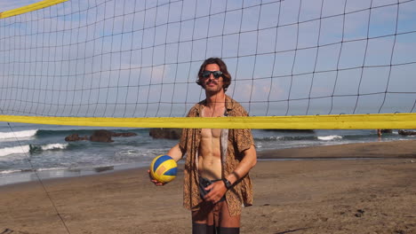 Man-playing-with-ball-on-the-beach.