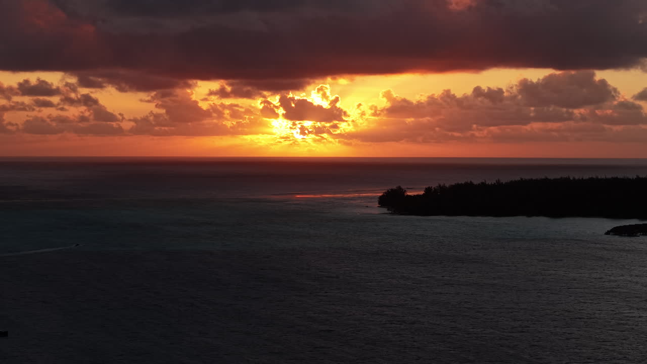 Aerial View of Sunset Above Bora Bora Island and Lagoon, French Polynesia. Clouds and South Pacific Ocean Horizon
