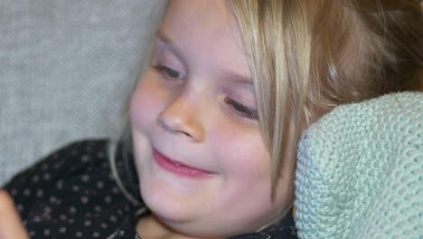 Extreme-Close-up-portrait-of-happy-five-year-old-girl-at-home,-shallow-depth-of-field-slow-motion