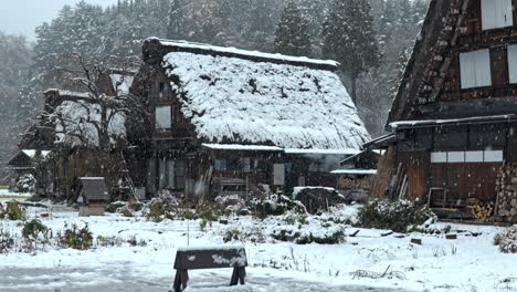 a serene snowfall blankets the unesco world heritage village of shirakawa-go, japan.
