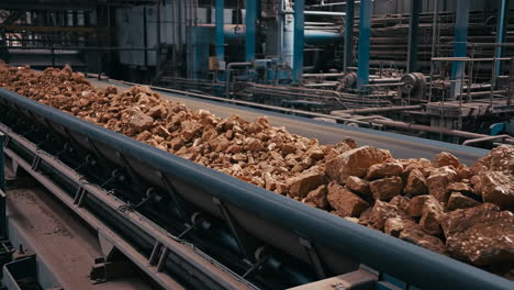 ore or rock transported on a conveyor belt in an industrial setting