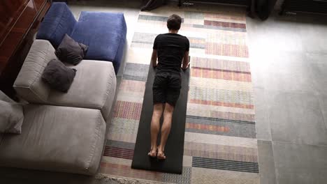 Above-footage-of-a-man-doing-push-up-exercise-at-home