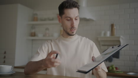 man giving a presentation in a kitchen