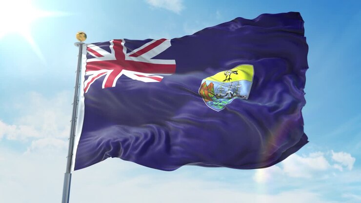 Saint Helena flag waving in the wind against deep blue sky. National theme, international concept. 3D Render Seamless Loop 4K